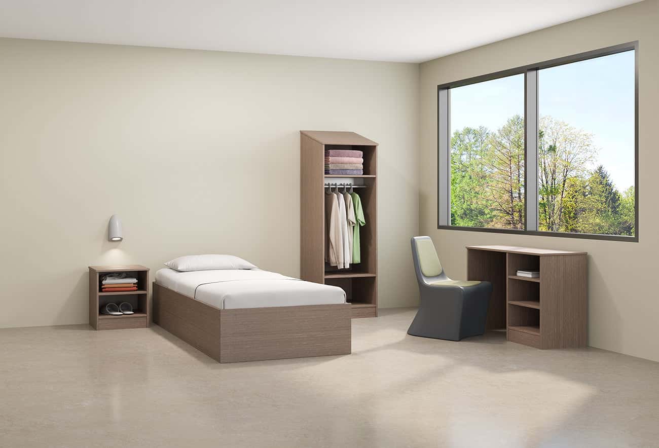 Calm, residential-feeling behavioral health environment furnished with ligature-resistant seating and casegoods