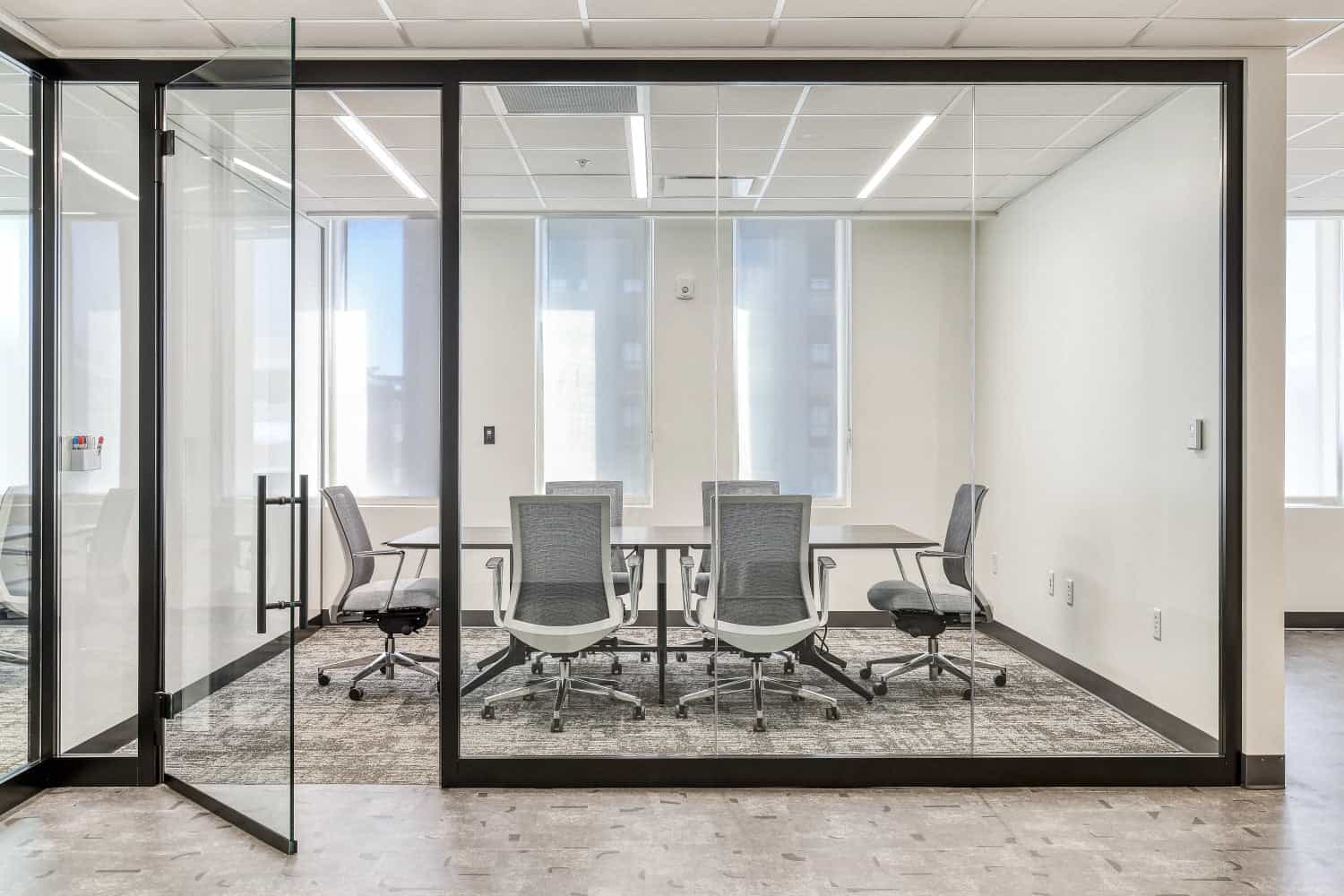 Premium corporate office interior with conference furniture, executive workstations, and glass partition walls in a Florida commercial building