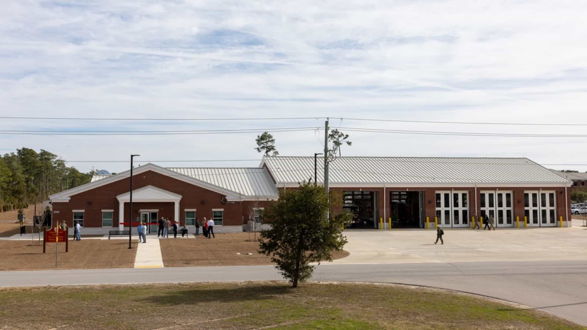 Newly constructed fire station with brick construction and open apparatus bay doors