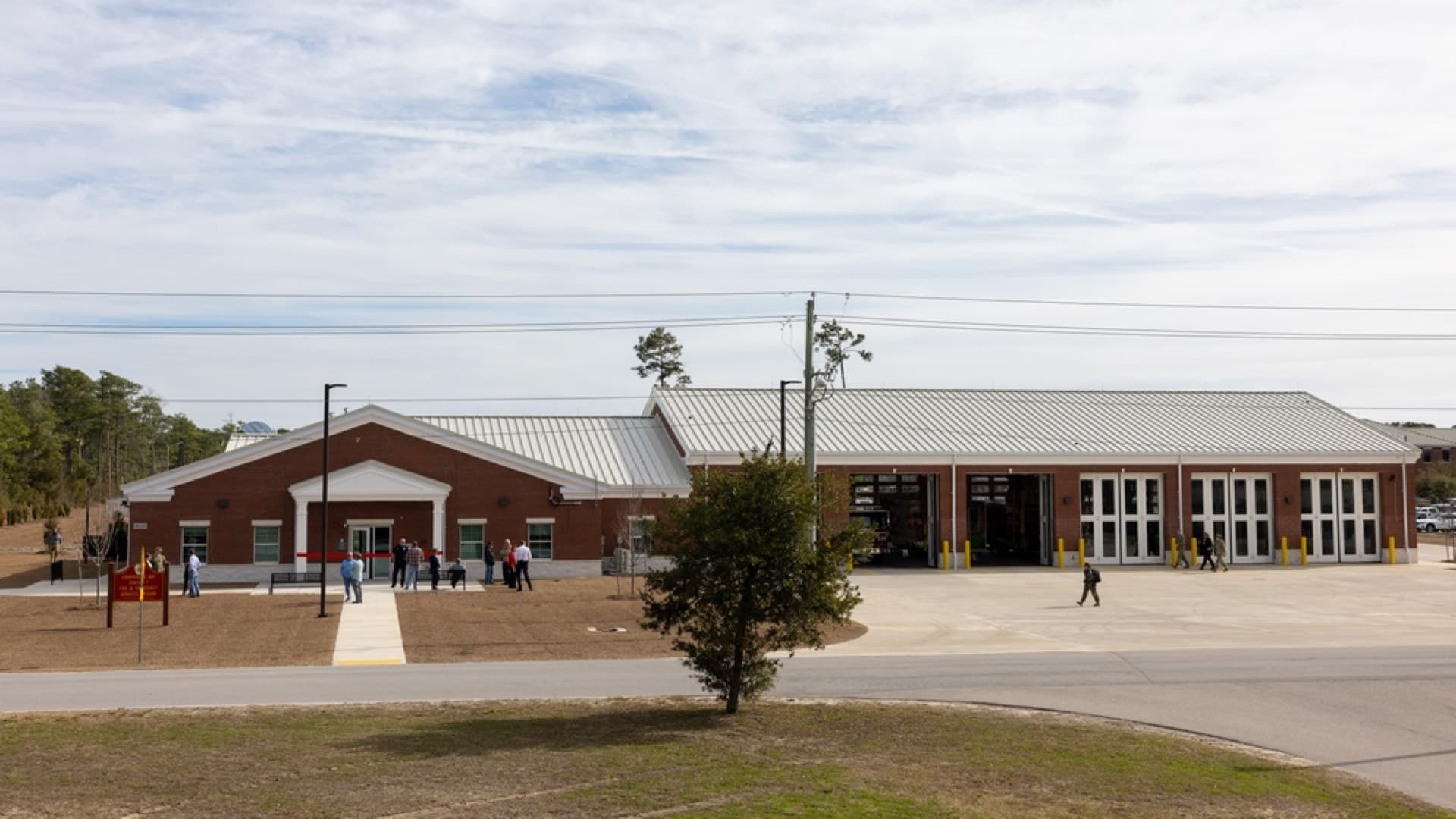Newly constructed fire station with brick construction and open apparatus bay doors